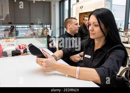 MINSK, BELARUS - January 2021: Disability Inclusion Team at an inclusive cafe. A unique project, an inclusive coffee shop. A place where all employees are disabled. Managed by a person with Down syndrome. All baristas are disabled.  Stock Photo