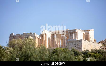 Acropolis of Athens Greece rock and Parthenon on blue sky background, sunny day. View from Dionisiou areopagitou street Stock Photo