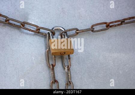 Heavy metal padlock with chain closeup on an entrance gate. Safety, security concept Stock Photo