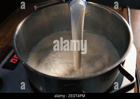 Over Boiling Brimming Milk In A Pot On Stove Stock Photo, Picture and  Royalty Free Image. Image 18143282.