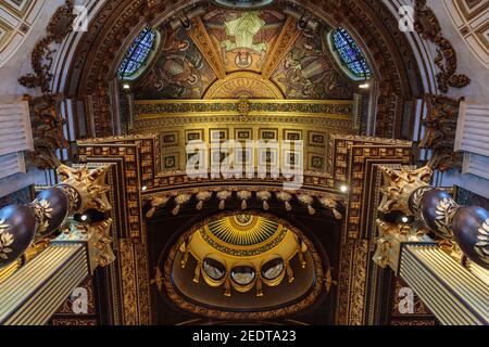 St Paul's Cathedral interior, view up to the murals, carvings and gilded decorations of the ceiling above the high altar, London UK Stock Photo