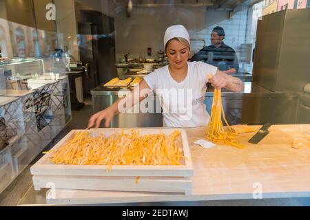 A woman making fresh pasta in a shop window in Bologna Italy Stock Photo
