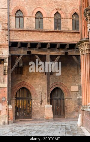 Ancient medieval archways and wooden supports in old buildings in Bologna Italy Stock Photo