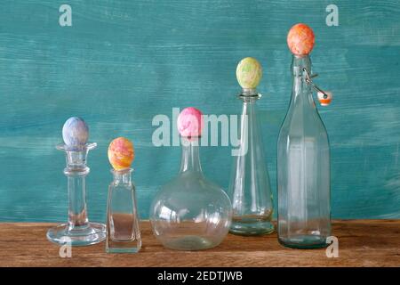 easter decoration with multicolored easter eggs and vintage glass bottles,easter mock up template,free copy space Stock Photo