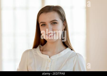 Head shot portrait of smiling attractive young woman. Stock Photo