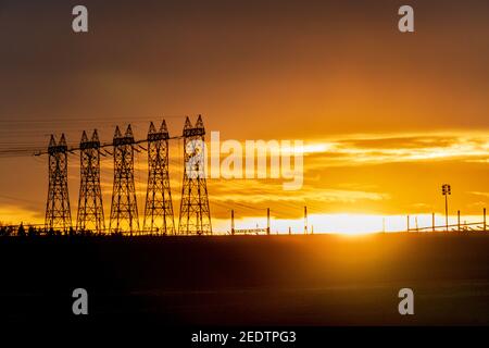 High voltage electric tower on sunset time and sky on sunset background. Power Tower Stock Photo