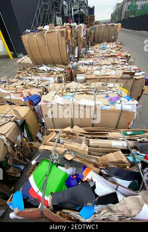 Cardboard and waste paper is collected and packaged for recycling. Cardboard is bundled into bales. Urban Recycling and storage. Stock Photo