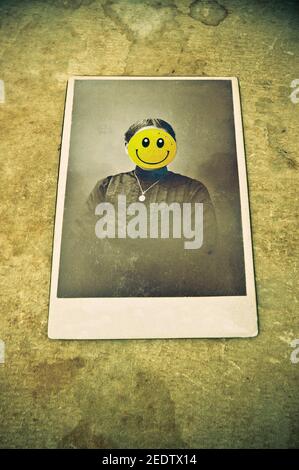 antique photo portrait of a woman with an emoticon covering her face Stock Photo