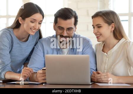 Three caucasian colleagues working together on online project. Stock Photo