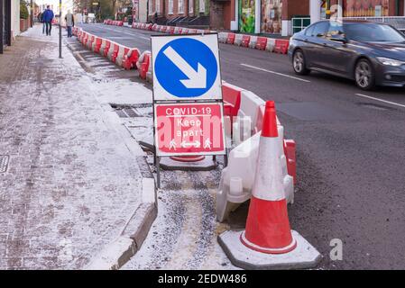 Covid-19 social distancing sign at widened pavement in Harborne, Birmingham Stock Photo