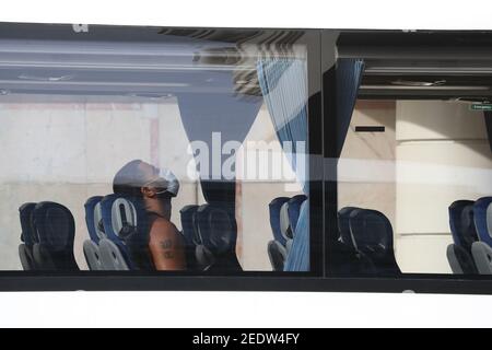 A passenger arrives by coach at the Radisson Blu Edwardian Hotel, near Heathrow Airport, London, one of the new Government managed quarantine facilities. New regulations now in force require anyone who has been in a high-risk location to enter England through a designated port and have pre-booked a package to stay at one of the Government's managed quarantine facilities. Picture date: Monday February 15, 2021. Stock Photo