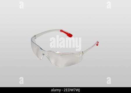Safety glasses are transparent. Close-up. Isolated on a gray background. Stock Photo