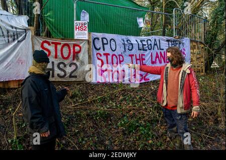 Wendover, Buckinghamshire, UK. 15th February, 2021. Stop HS2 activists outside one of their Wendover camps. HS2 Ltd have this morning fenced off a public footpath and started fencing off an area of woodland known as the Spinney in readiness to fell numerous mature trees as part of the High Speed 2 rail link from London to Birmingham. The landowner was allegedly not notified by HS2 Ltd in advance. National Eviction Team (NET) bailiffs working for HS2 were on site as were a large number of police who were using a drone above the woods. Anti HS2 activists are living in the woods nearby in an atte Stock Photo