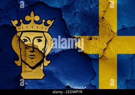 flags of Stockholm and Sweden painted on cracked wall Stock Photo