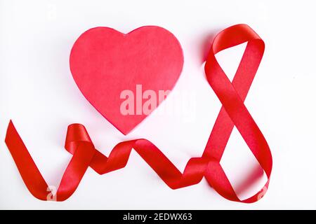Number 8 from red silk ribbon on white background. International women's day symbol. Spring holiday on March 8. Stock Photo