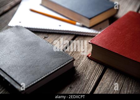 Business concept, ideas, books and exercise book on a wooden background with pencils Stock Photo