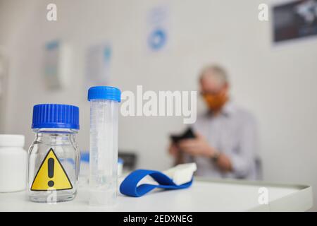 Close up background image of bio samples with warning sign on desk in doctors office, copy space Stock Photo
