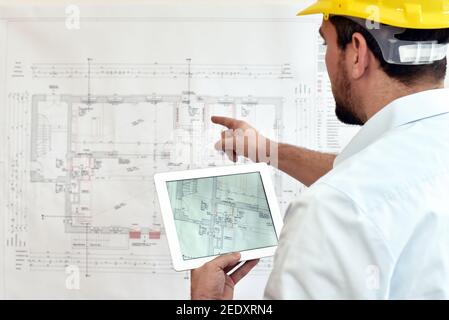 ArchitectPlanning Construction of a house on the Boaerd with the technical drawing - floor plan Stock Photo