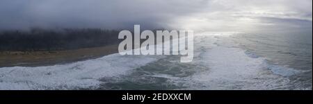 Fog shrouds the forested coast of Northern California near Klamath. This region is known for its magnificent Redwood forests and rugged coastline. Stock Photo