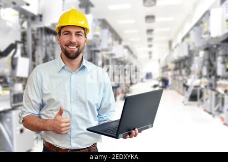 engineer at his workplace with notebook in an industrial company in microchip manufacturing plant Stock Photo