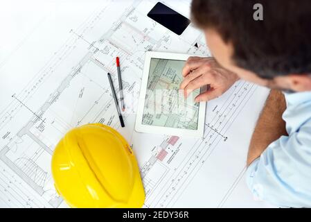 ArchitectPlanning Construction of a house on the Boaerd with the technical drawing - floor plan Stock Photo