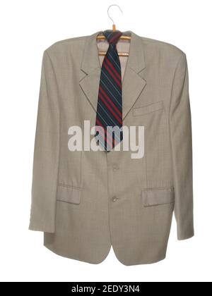Gray jacket with dark tie on wooden hanger with metal hook isolated on white background Stock Photo