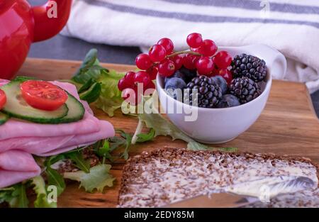 A bowl with fresh berries on a breakfast table Stock Photo