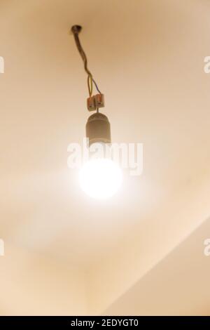 Light bulb on the ceiling in the house. Selective focus. white. Stock Photo