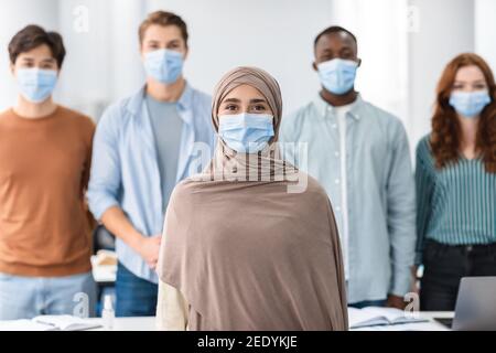 Diverse group of international people wearing medical protective face masks Stock Photo