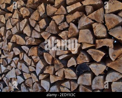Closeup view of wood heap with stacked cut logs with wooden texture and age rings in forest in Swabian Alb, Germany. Focus on center-right. Stock Photo