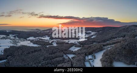 Sunset in winter with snow and ice with view from Rusel towards Schaufling and Landshut, Germany Stock Photo