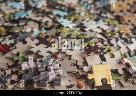 Jigsaw puzzle. Pile of jigsaw puzzle peices. Conceptual photo with focus on undone puzzle Stock Photo