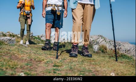 Three people practicing trekking outdoors Stock Photo