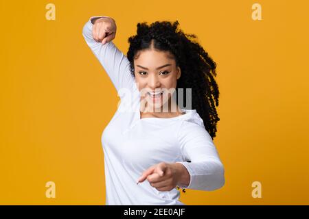 Gotcha. Excited beautiful african american woman pointing at camera with two hands Stock Photo