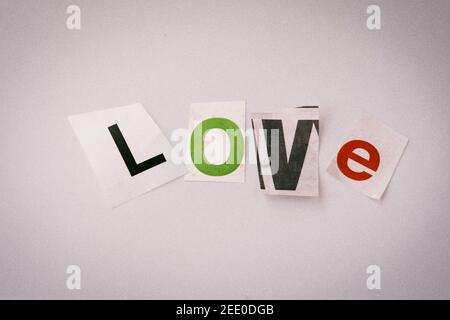 The word LOVE on a bulletin board using cut-out paper letters in