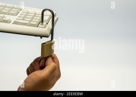 Computer keyboard unsecured with an open padlock. White text free space Stock Photo