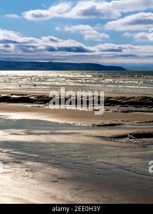 The sandy beach at Barmouth Bay or Abermaw in Gwynedd on the north west coast of Wales with the mountains of Snowdonia in tne distance. Stock Photo