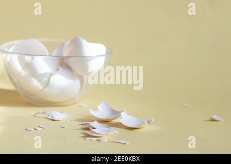 broken egg shell on yellow background with space for text, begging of life concept Stock Photo