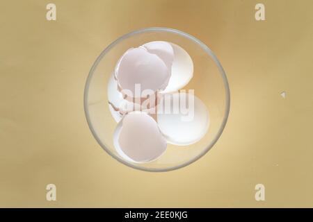broken egg shell on yellow background with space for text, begging of life concept Stock Photo