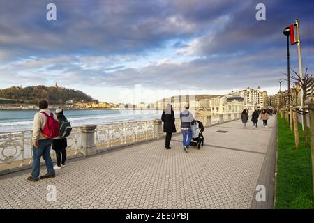 2020 02, San Sebastian - Spain. Walker on the promenade along La Concha beach