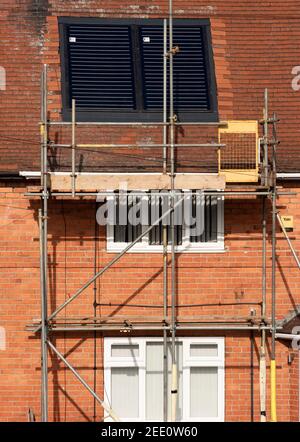 Solar panel installation on a house roof UK Stock Photo