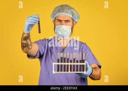 Critical number or density of susceptible hosts. Man in medical lab inspecting samples biological material. Epidemic disease. Virus concept. Epidemic infection. Genetic analysis. Epidemic threshold. Stock Photo