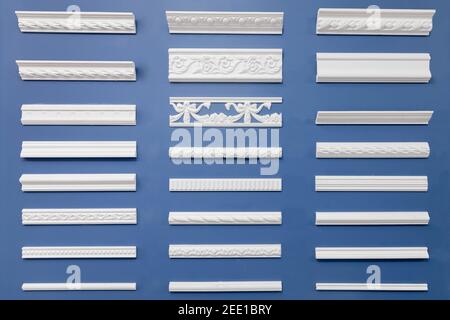Set wood molding ceiling and floor skirting board on isolated blue background. Stock Photo
