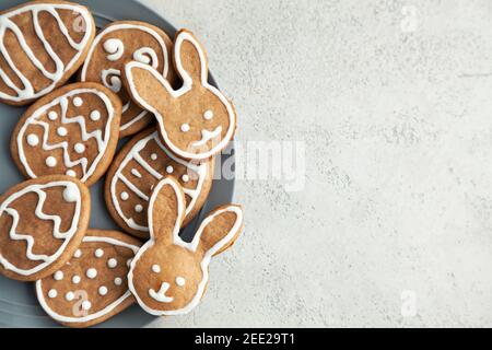 Easter cookies on a grey plate on a stone background. Easter bunnies. Stock Photo