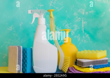 Cleaning product, household, sanitary supplies.Variety of colorful house cleaning products on blue background.Clean up and spring-cleaning concept Stock Photo