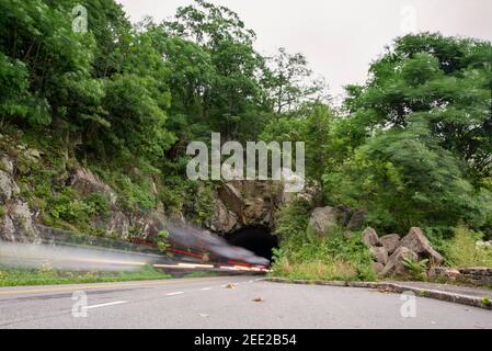 Cars zoom through the Thornton Gap Tunnel at Shenandoah National Park in Virginia. Motion Blur. Stock Photo