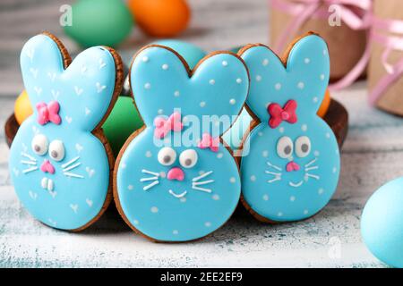 Easter funny rabbits, homemade painted gingerbread biscuits in glaze and painted eggs Stock Photo