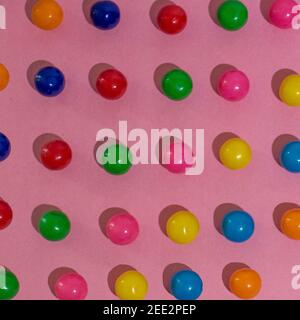 Candy is arranged on colorful paper creating repetitive patterns. Series.