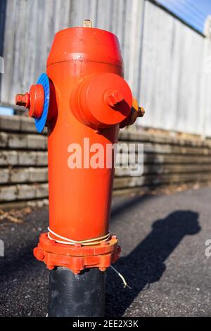 Bright Red Fire Hydrant on Roadside Stock Photo