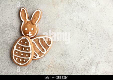 Tasty Easter cookies on a grey table. Bunnies and eggs cookies for holiday,top view and copy space. Stock Photo